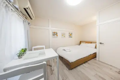 a small bedroom with a bed and a desk at 7 min to JR Otsuka,Direct Yamanote Line ,1 stop to Ikebukuro,Direct to Shinjuku ,Shibuya,Fully Renovated,18 sqm,2 Guests #102 in Tokyo