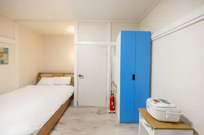 a bedroom with a bed and a blue cabinet at 7 min to JR Otsuka,Direct Yamanote Line ,1 stop to Ikebukuro,Direct to Shinjuku ,Shibuya,Fully Renovated,18 sqm,2 Guests #102 in Tokyo