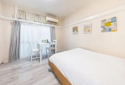 a bedroom with a bed and a table and a chair at 7 min to JR Otsuka,Direct Yamanote Line ,1 stop to Ikebukuro,Direct to Shinjuku ,Shibuya,Fully Renovated,18 sqm,2 Guests #102 in Tokyo