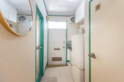a hallway with a door and a mirror at 7 min to JR Otsuka,Direct Yamanote Line ,1 stop to Ikebukuro,Direct to Shinjuku ,Shibuya,Fully Renovated,18 sqm,2 Guests #102 in Tokyo