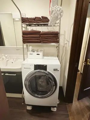 a washer and dryer in a bathroom with a sink at 4 min to JR Entire 3BR House w Garage Family Friendly Fast WiFi in Tokyo