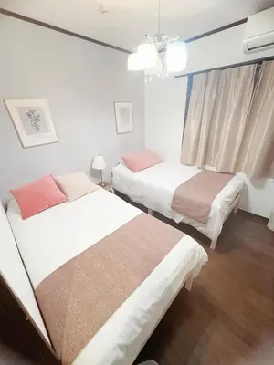 a bedroom with two beds and a window at 4 min to JR Entire 3BR House w Garage Family Friendly Fast WiFi in Tokyo