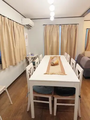 a dining room with a white table and chairs at 4 min to JR Entire 3BR House w Garage Family Friendly Fast WiFi in Tokyo