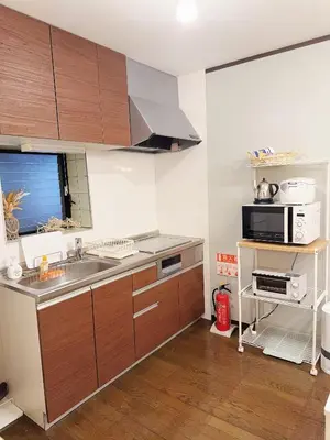 a kitchen with a sink and a microwave at 4 min to JR Entire 3BR House w Garage Family Friendly Fast WiFi in Tokyo