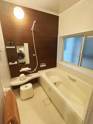 a bathroom with a tub and a toilet and a sink at 4 min to JR Entire 3BR House w Garage Family Friendly Fast WiFi in Tokyo