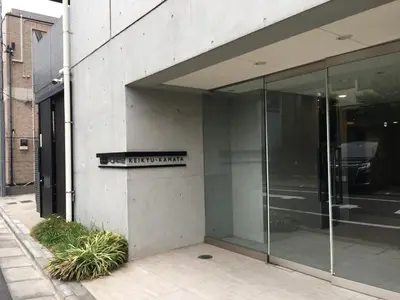 a glass building with a sign on the side of it at SYFORME KEIKYU-KAMATA Room210 in Tokyo