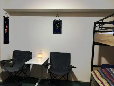 a room with two chairs and a table and a bed at SYFORME KEIKYU-KAMATA Room210 in Tokyo