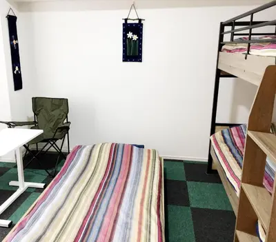 a room with two bunk beds and a table and a desk at SYFORME KEIKYU-KAMATA Room210 in Tokyo
