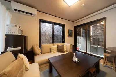 a living room with a couch and a table at Private rental house Yado Torigoe in Tokyo