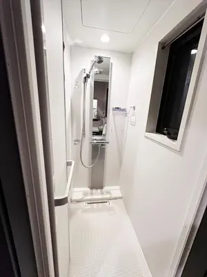 a white bathroom with a shower and a sink at Private rental house Yado Torigoe in Tokyo