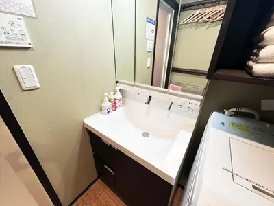 a bathroom with a sink and a mirror at Private rental house Yado Torigoe in Tokyo