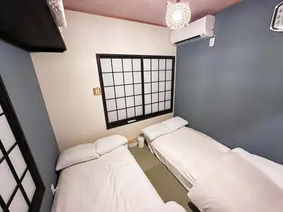 two beds in a room with a window at Private rental house Yado Torigoe in Tokyo