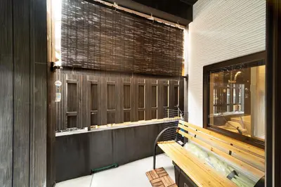 a bench in a room with a fish tank at Private rental house Yado Torigoe in Tokyo
