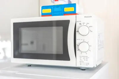 a white microwave oven sitting on top of a counter at Live the Anime Dream! Unique Themed Guest House for Families & Groups in Tokyo in Tokyo