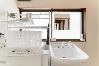 a bathroom with a white sink and a window at Kasai Hotel near Shinjuku, Akihabara, Asakusa TDR-Disney T-LAB \u4e00\u68df\u307e\u308b\u307e\u308b\u845b\u897f\u30db\u30c6\u30eb\u6700\u59279\u540d in Tokyo