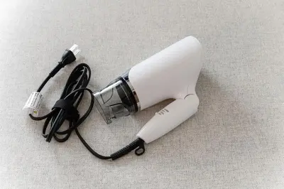 a hair dryer with a cord on a table at Kasai Hotel near Shinjuku, Akihabara, Asakusa TDR-Disney T-LAB \u4e00\u68df\u307e\u308b\u307e\u308b\u845b\u897f\u30db\u30c6\u30eb\u6700\u59279\u540d in Tokyo