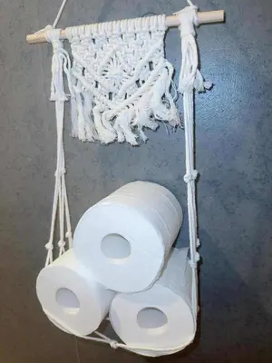 a roll of toilet paper hanging from a wall at The Rose Ueno in Tokyo