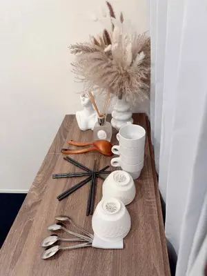 a table with white vases and utensils on it at The Rose Ueno in Tokyo