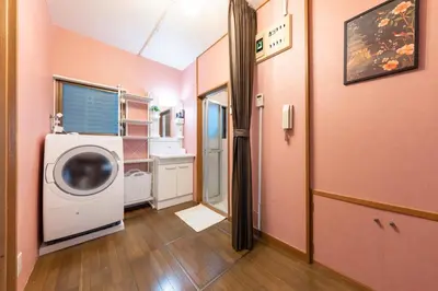 a laundry room with a washing machine in a room at Matsubara Station 2 minutes Shinjuku, Shibuya 15 minutes Pure Japanese style house where you can feel the seasons Maximum 6 people rent a house Quiet house in Tokyo