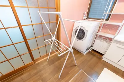 a washer and dryer in a laundry room at Matsubara Station 2 minutes Shinjuku, Shibuya 15 minutes Pure Japanese style house where you can feel the seasons Maximum 6 people rent a house Quiet house in Tokyo