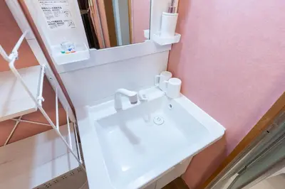 a bathroom with a white sink and a mirror at Matsubara Station 2 minutes Shinjuku, Shibuya 15 minutes Pure Japanese style house where you can feel the seasons Maximum 6 people rent a house Quiet house in Tokyo