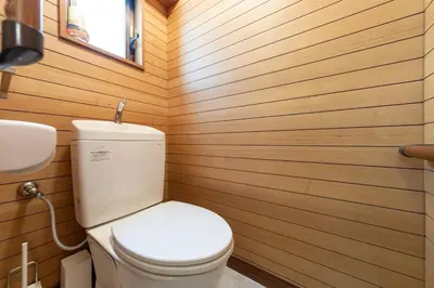 a bathroom with a toilet and a wooden wall at Matsubara Station 2 minutes Shinjuku, Shibuya 15 minutes Pure Japanese style house where you can feel the seasons Maximum 6 people rent a house Quiet house in Tokyo