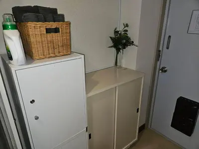 a white cabinet with a basket on top of it at \u30db\u30c6\u30eb\u30ec\u30b9\u30dd\u30ef\u30fc\u30eb402 in Tokyo