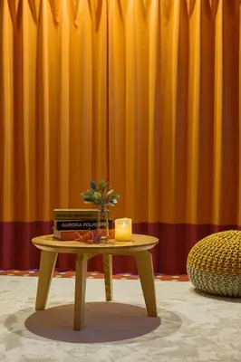 a table with a candle and books on top of it at Skytree View Rooftop Villa Asakusa SVRVA in Tokyo