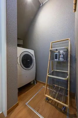 a laundry cart next to a washing machine in a room at Skytree View Rooftop Villa Asakusa SVRVA in Tokyo