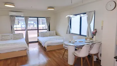 a bedroom with two beds and a table with a desk at SkyTree-401 in Tokyo