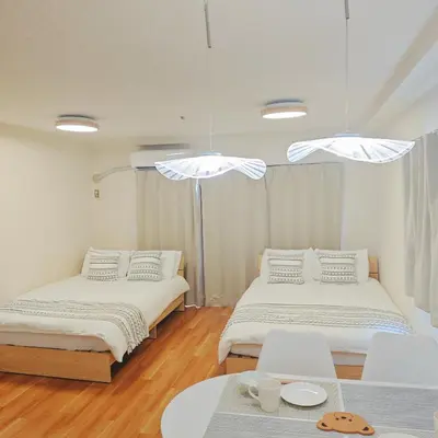 a bedroom with two beds and a table and chairs at SkyTree-401 in Tokyo