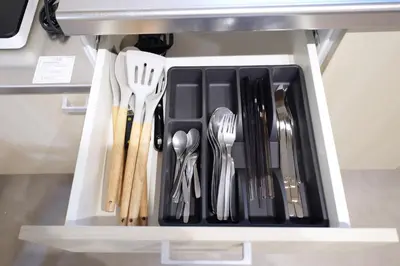 a drawer filled with silver utensils in a cabinet at Yumenoya Yoyogi in Tokyo