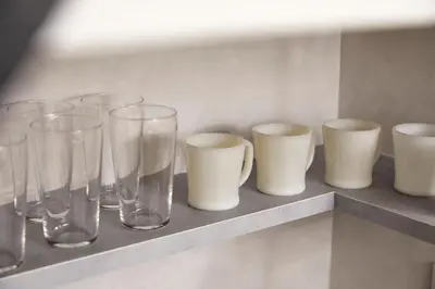 a row of glasses and cups sitting on a shelf at \u3068\u307e\u308a\u30fc\u3068Stay\u65b0\u5bbf Tomareat Stay Shinjuku in Tokyo