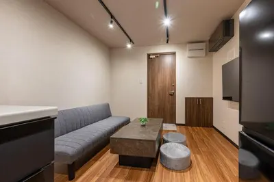 a living room with a couch and a table at Newly Opened \u6c60\u888b\u30c6\u30e9\u30b9\u30cf\u30a6\u30b9A in Tokyo