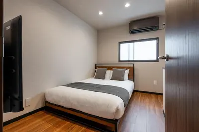 a bedroom with a bed and a window and a television at Newly Opened \u6c60\u888b\u30c6\u30e9\u30b9\u30cf\u30a6\u30b9A in Tokyo