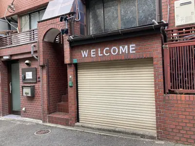 a store with two garage doors on a brick building at Newly Opened \u6c60\u888b\u30c6\u30e9\u30b9\u30cf\u30a6\u30b9A in Tokyo