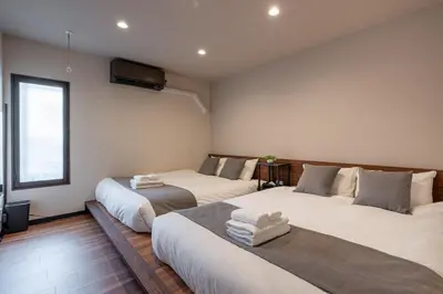 a bedroom with two beds with towels on them at Newly Opened \u6c60\u888b\u30c6\u30e9\u30b9\u30cf\u30a6\u30b9A in Tokyo