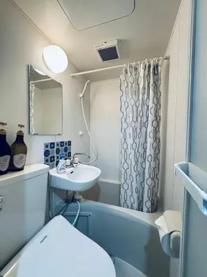 a bathroom with a sink and a shower curtain at Shinjuku JX-101 SJ0283 in Tokyo