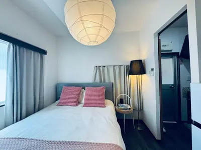 a bedroom with a bed with two pink pillows at Shinjuku JX-101 SJ0283 in Tokyo