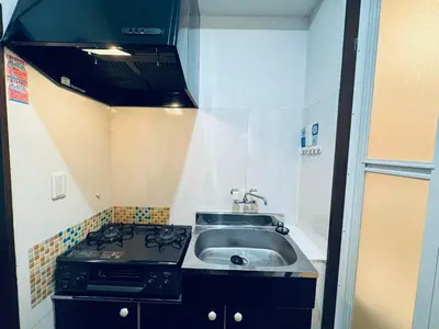 a kitchen with a sink and a stove at Shinjuku JX-101 SJ0283 in Tokyo