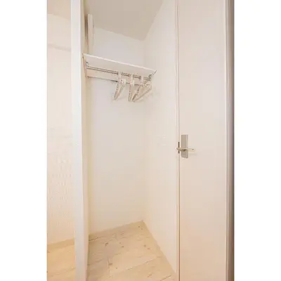 a walk in closet with a glass shower door at Japan House Shirokane in Tokyo
