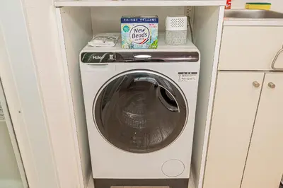 a washer and dryer in a small room at Japan House Shirokane in Tokyo