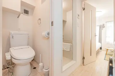a bathroom with a toilet and a walk in shower at Japan House Shirokane in Tokyo
