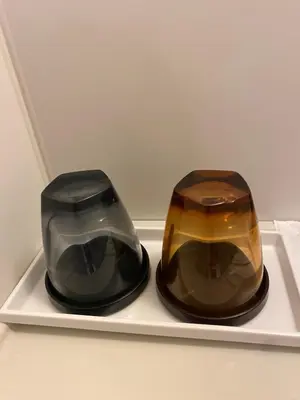 two vases are sitting on a white shelf at Omori Happy Smile Hotel in Tokyo