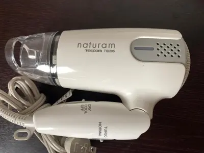 a white hair dryer sitting on top of a stand at Omori Happy Smile Hotel in Tokyo