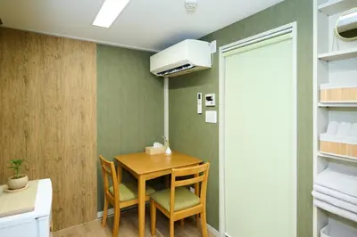 a dining room with a table and two chairs at 1min to Station 25min Disney Resort Direct Narita 1Transfer Shibuya CVS 30s Girls Trip Family Stay \u99c5\u5f92\u6b691\u5206 \u30c7\u30a3\u30ba\u30cb\u30fc\u30ea\u30be\u30fc\u30c825\u5206 \u6210\u7530\u7a7a\u6e2f\u76f4\u901a \u6e0b\u8c371\u56de\u4e57\u63db \u30b3\u30f3\u30d3\u30cb30\u79d2 \u5973\u5b50\u65c5 \u5bb6\u65cf\u65c5\u884c in Tokyo