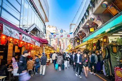 a crowd of people walking through a market at Heureux Shiinamachi 201 in Tokyo