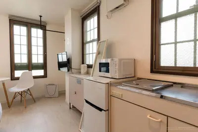 a kitchen with a microwave on top of a counter at R Inn \u65b0\u4e95\u85ac\u5e2b\u524d in Tokyo