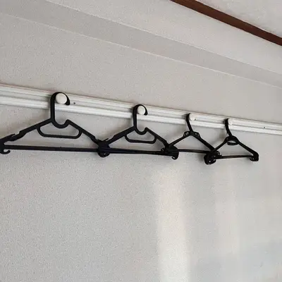 a black curtain rod hanging from a ceiling at \u6953 -Kaede- in Tokyo