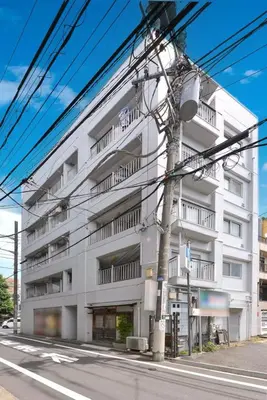 a white building on the side of a street at \u6953 -Kaede- in Tokyo